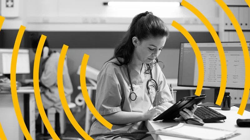 Doctor using a medical tablet being monitored by Statseeker network performance monitoring tool